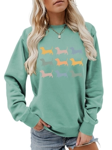 Detail of mint green sweatshirt featuring 9 colorful dachshund puppy prints and ribbed cuffs