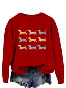 Detail of red crewneck sweatshirt featuring nine colorful dachshund dog silhouettes