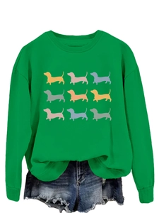 Close-up of bright green sweatshirt featuring nine colorful dachshund dog silhouettes