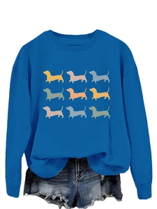 Detailed view of royal blue round neck sweatshirt with nine colorful dachshund puppy prints