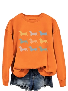 Detail of orange sweatshirt featuring nine colorful dachshund silhouette prints on front