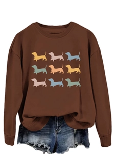Close-up of brown crewneck sweatshirt featuring nine colorful dachshund silhouettes prints