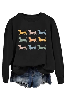 Detail view of colorful dachshund silhouette prints on a black crewneck sweatshirt