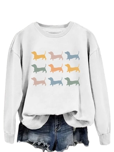 Flat lay of white crewneck sweatshirt featuring nine colorful dachshund dog silhouettes