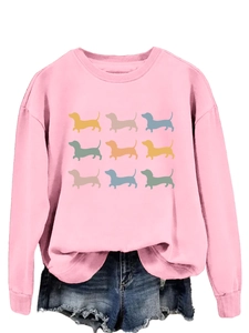 Close-up of pink crewneck sweatshirt with nine colorful dachshund silhouettes print