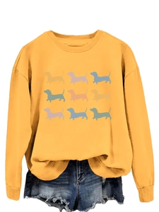 Detail of crewneck sweatshirt in mustard yellow with nine colorful dachshund prints