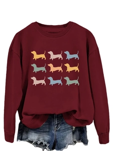 Detail of burgundy sweatshirt featuring a nine-grid colorful dachshund silhouette print