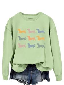 Detail of mint green sweatshirt featuring a 3x3 grid of colorful dachshund silhouettes