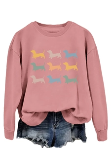 Detail of pink crewneck sweatshirt featuring nine colorful dachshund silhouette prints