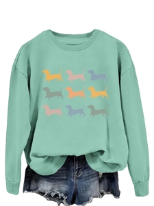Detail of mint green sweatshirt with cute nine colorful dachshund dog silhouettes print