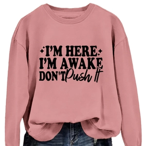 Pink crewneck sweatshirt with I'm Here I'm Awake slogan in a casual loose fit style