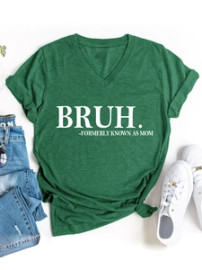 Detailed flat lay of green V-neck T-shirt with 'BRUH' print, jeans, and white sneakers