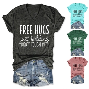 Flat lay of V-neck T-shirt in multiple colors and distressed denim shorts ensemble