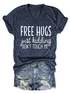 Detailed flat lay of V-neck navy t-shirt with Free Hugs text and distressed denim shorts
