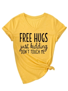 Detail of yellow V-neck T-shirt with 'Free Hugs' print and side knot design