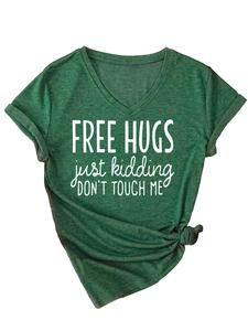 Macro detail of V-neck T-shirt in dark green with Free Hugs print and stylish front knot