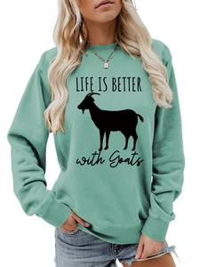 Detail of mint green crewneck sweatshirt featuring Life Is Better With Goats print