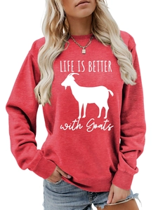 Detail of red crewneck sweatshirt featuring white goat graphic and Life Is Better text