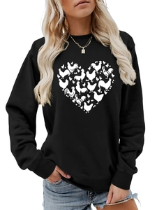 Detail shot of heart-shaped chicken and egg print on a black long-sleeved sweatshirt