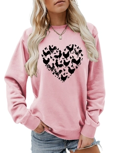 Close-up of heart-shaped chicken silhouette print on pink crewneck sweatshirt