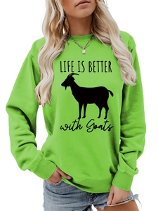 Detail of LIFE IS BETTER with Goats graphic print on a green crewneck sweatshirt
