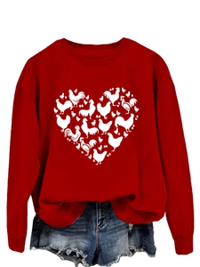 Close-up of red crewneck sweatshirt with heart-shaped chicken and egg graphic print
