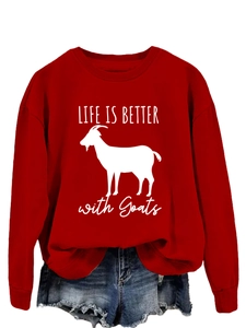 Flat lay of red sweatshirt with Life is Better with Goats print and denim shorts