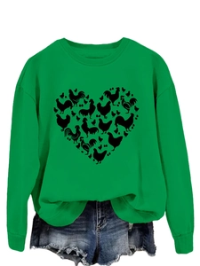 Detail of green crewneck sweatshirt featuring a heart-shaped chicken and egg print design