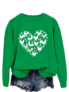 Detail of green crewneck sweatshirt with heart-shaped chicken print and denim shorts