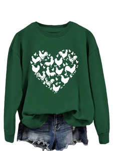 Detail of chicken heart print on dark green sweatshirt with vintage denim shorts