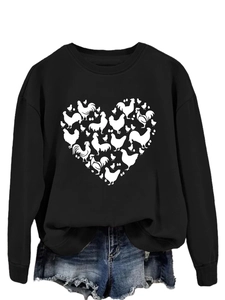 Close-up of black sweatshirt with a heart-shaped chicken and egg print design