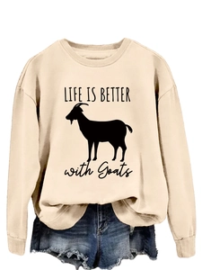 Flat lay of a beige sweatshirt featuring a goat graphic and Life is Better print with shorts