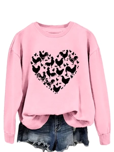 Detailed close-up of pink crewneck sweatshirt with creative heart-shaped chicken pattern
