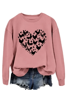 Detail of pink sweatshirt featuring a heart-shaped pattern composed of chicken silhouettes