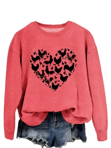 Detail of pink sweatshirt featuring heart-shaped chicken and egg print with ribbed cuffs