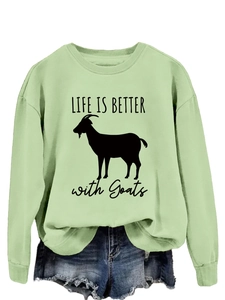 Close-up of light green sweatshirt featuring black goat silhouette and slogan