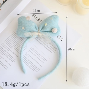 Serre-tête de Noël bleu avec nœud doré et détails paillettes flocons de neige