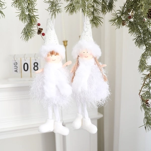 Detailed view of white Christmas angel ornaments with sequins and feather skirts on pine branch