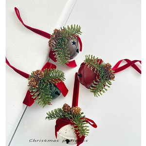 Set of four rustic Christmas bells with pine needles, cones, and velvet bows for tree decor