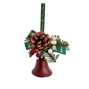 Detail of Christmas bell with pine cones, berries, and Merry Christmas ribbon