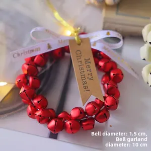 Detail of a 10cm Christmas bell wreath with 1.5cm red bells and a Merry Christmas tag