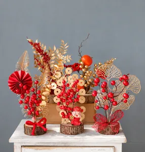 Detailed view of Chinese New Year decor with red berries, gold leaves and wooden base