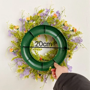 Detail showing artificial purple and yellow flower wreath with 20cm inner diameter size
