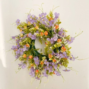 Artificial purple flower wreath with green leaves and orange buds for home wall decoration