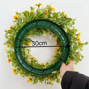 Rear view of 30cm artificial spring wreath with yellow daisy flowers and green leaf base