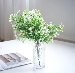 Detail of white jasmine flower bouquet in textured glass vase for Nordic home decor
