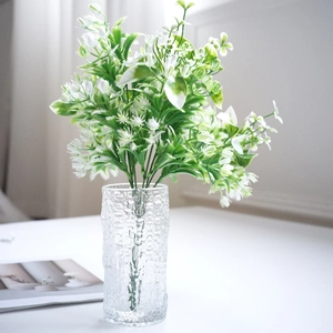 Artificial white jasmine flowers in clear hammered glass vase for home desk decor