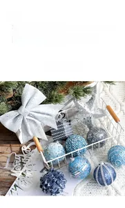 Detail of glittery silver bow and blue Christmas ornaments with Merry Christmas sign