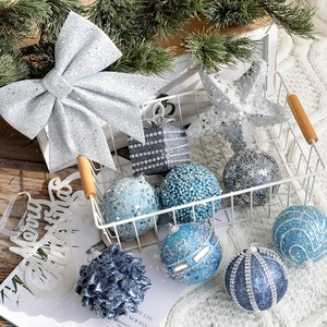 Blue and silver Christmas ball ornaments with glitter and bows in a basket
