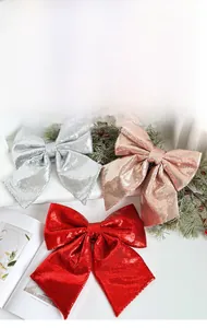 Detail of glitter Christmas bows in red, silver, and rose gold for tree decoration